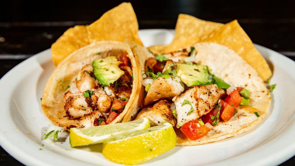 Tiger Prawn Taco · Soft corn tortillas with prawns grilled with fresh salsa, topped with cilantro, onion, avocado.