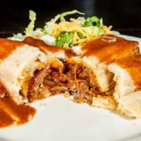 Tamale · Homemade pork tamale topped with mole (enchilada sauce), lettuce and cheese.