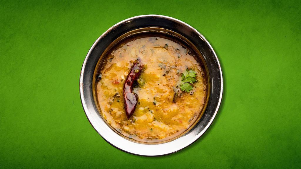 Divine Daal Yellow · Yellow Lentil tempered with onion and tomatoes on a low flame with spices