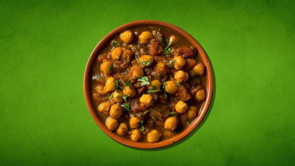 Spiced Chickpea Fiesta · Delicious chickpeas cooked in an exotic blend of  Indian spices and garnished with cilantro.