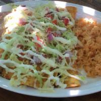 Enchiladas Acapulco · Two Corn tortillas dip in a red sauce with your choice of meat, beans and rice, garnish with...