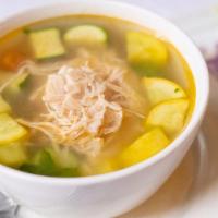 Caldo De Pollo · chicken soup with vegetables served with avocado, chiles, lime, and rice.