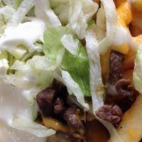 Asada Fries · Fries topped with asada and smothered in cheese and sour cream.