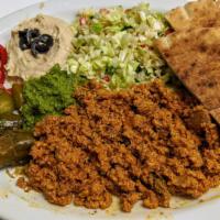 Ground Chicken Plate · Ground Chicken cooked with Tomatoes, spices and herbs. Served with Hummus, Israeli salad, Pi...