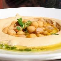 Classic Hummus  · Hummus served with 2 Pitas, Pickles, Tahini sauce and topped with choice of plain olive oil ...