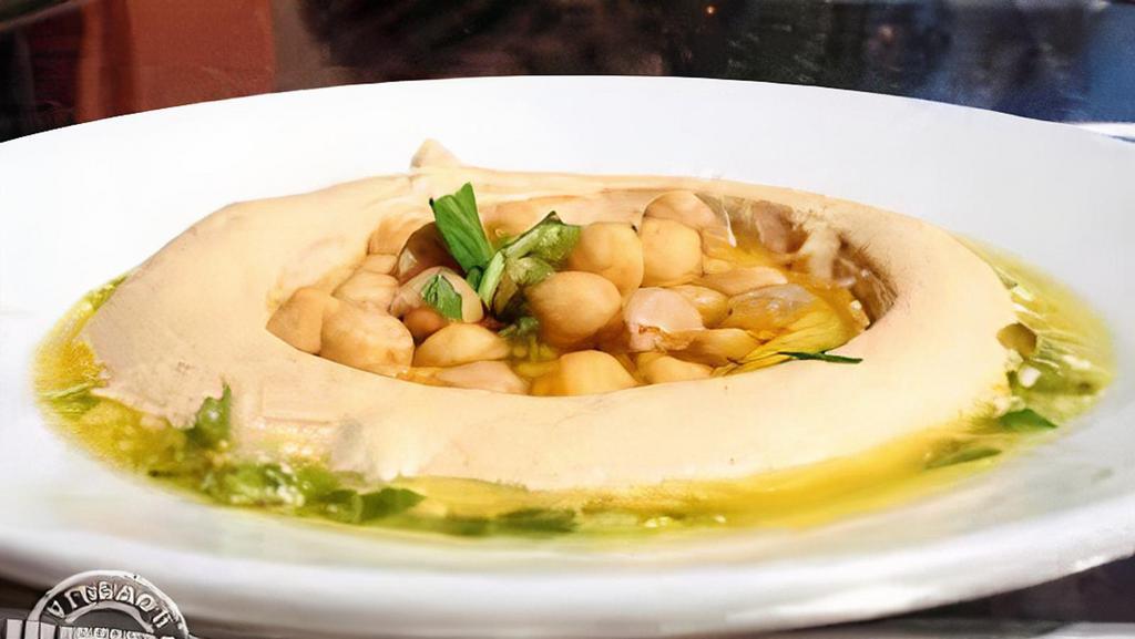 Classic Hummus  · Hummus served with 2 Pitas, Pickles, Tahini sauce and topped with choice of plain olive oil or lemon relish (Olive oil, parsley, lemon juice and Garlic).  Hummus is made of ground Garbanzo beans, imported Tahini sauce, olive oil, and spices. Vegan, vegetarian, and gluten-free.