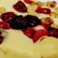 Cranberry Walnut Cheesecake · Cream cheese cake topped with Cranberries and Walnuts.