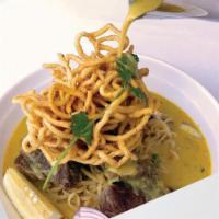 Kow Soi Neur · Combination of crispy egg noodle and egg noodle serve with boneless beef short rib, red onio...