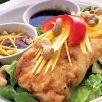 Pla Tod Nampla · Crispy fillet cod serve with signature sweet fish sauce, lettuce, cashews, bell pepper, and ...