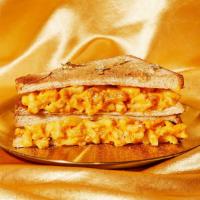 Maxed Out Grilled Mac And Cheese · It's mac and cheese... on grilled cheese! Crisp bacon, gooey mac and cheese, and melted ched...