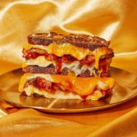 Chicken Bbq Cutie Grilled Cheese · A grilled cheese with a touch of Texas. BBQ roasted chicken with caramelized onions, BBQ sau...