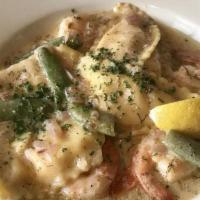 Lobster Ravioli and Prawns · Prawns, Shallots, edamame, Tomatoes, and Hand Made Lobster Ravioli Tossed in Lemon Dill Sauce.