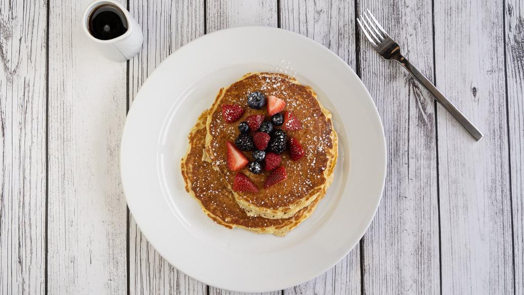 Buttermilk Pancakes · Vegetarian. Two scratch-made buttermilk pancakes topped with berries, fresh whipped butter, breakfast syrup and dusted with powdered sugar.