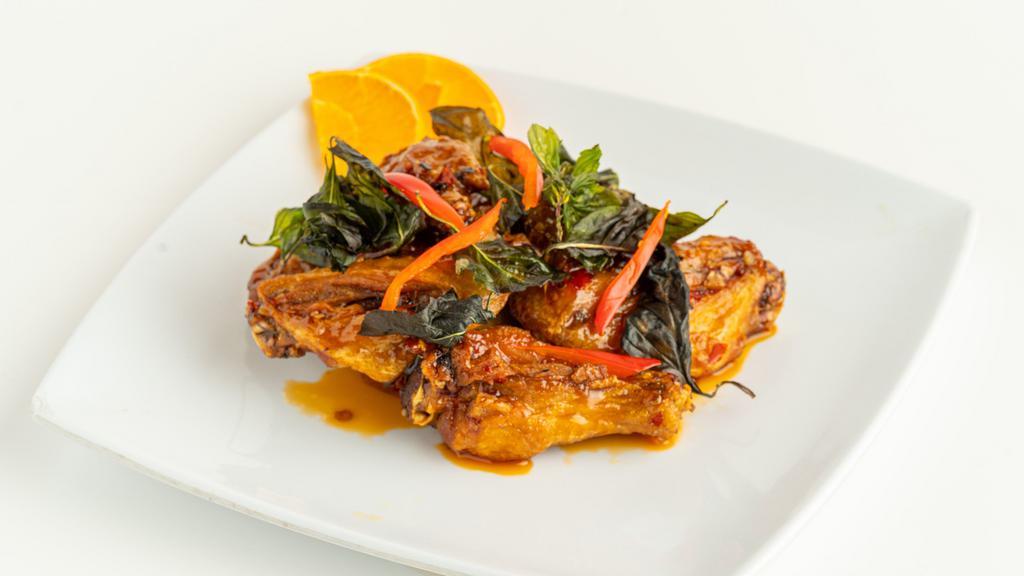 Angel Wings · Fried chicken wings tossed in sweet & spicy garlic sauce topped with fried basil