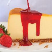 New York Style Cheesecake · Vanilla cheesecake with graham cracker crust topped with strawberry or caramel sauce, or ser...