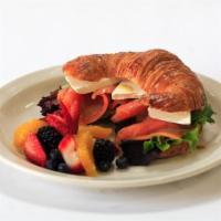 Salmon Croissant Sandwich · Smoked salmon and cream cheese on a croissant with a fruit side.