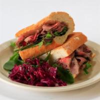 Pepper Tri-Tip of Beef Sandwich · In red wine sauce.
Cabbage on the side