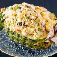 Pineapple Fried Rice · Fresh pineapple, ham, cashews raisins, prawns, and vegetables served in a fresh cut Hawaiian...