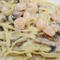 Shrimp Alfredo · Shrimp, mushrooms, garlic with cream and parmigiano cheese sauce over fettuccine.