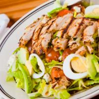 The Maverick Cobb · Romaine lettuce tossed in ranch dressing, blue cheese crumbles, grilled chicken fillet, baco...