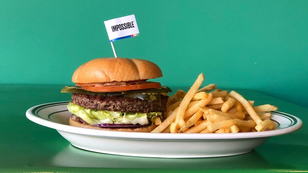 Impossible Burger (Vegetarian) · Meat made from plants patty- topped with Mavericks Burger sauce, iceberg lettuce, tomato, red onion and dill pickles served on an American burger bun. Vegetarian.