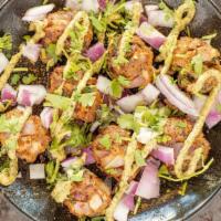 Lamb Kebab Bites · Spicy Ground Lamb Marinated in Kebab Spices topped with Red Onions, Mint Chutney, Fresh Lemo...