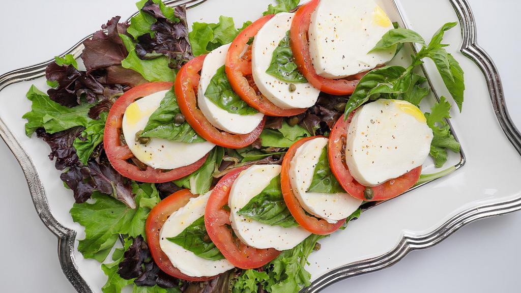 Caprese Salad · Fresh Mozzarella, Tomato, Basil, Olive Oil, Balsamic Vinegar, Kalamata Olives, Salt & Pepper. Served with French Bread