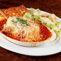 Lasagna · Home-made four cheese beef lasagna with cheddar, mozzarella, ricotta, and romano with zucchi...