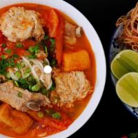 Bún Riêu · Crab and tomato noodle soup with fried tofu, ham, and pork blood