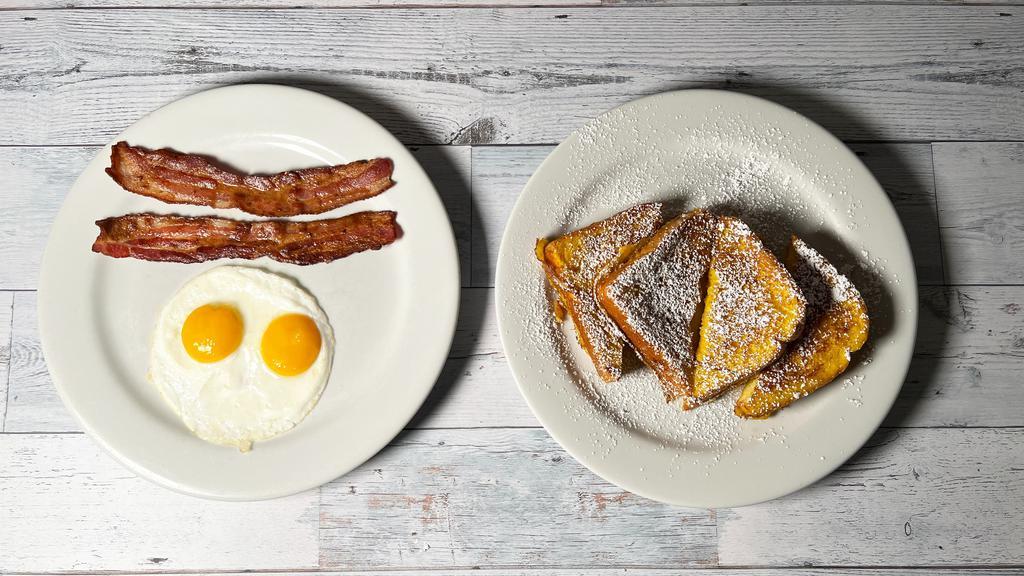 French Toast Combo · Two eggs, two strips of bacon or sausage, powdered sugar.