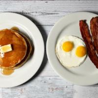 Continental · Two eggs, two pieces of bacon or sausage, pancakes or waffle, juice or coffee.