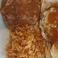 Huevos Rancheros · Eggs over easy served over corn tortillas, topped with a red sauce, and cheese, alongside ri...