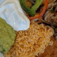 Fajitas · Choice of beef or shrimp, served with rice, refried beans, guacamole, sour cream and tortill...