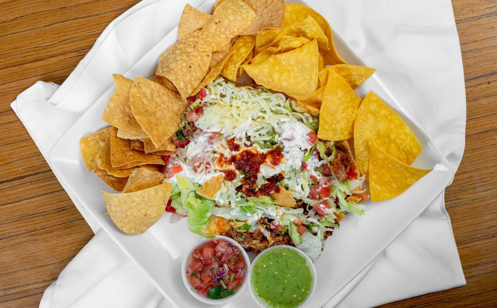 Tostada · One, served with choice of meat, refried beans, lettuce, tomatoes, cheese, sour cream, and guacamole.