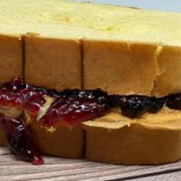 PB&J · Creamy peanut butter with grape jelly on fluffy white bread.