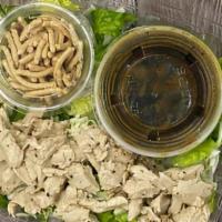 Classic Chinese Chicken Salad · Shredded vegan chicken with sesame ginger dressing, topped with rice noodles on a bed of rom...