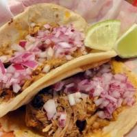 Cochinita · Slow-cooked pork marinated, pickled onions, habanero, and handmade corn tortilla. (Two tacos)