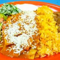 Chilaquiles · Delicious pieces of corn tortilla seasoned with spicy red sauce, topped with sour cream, che...