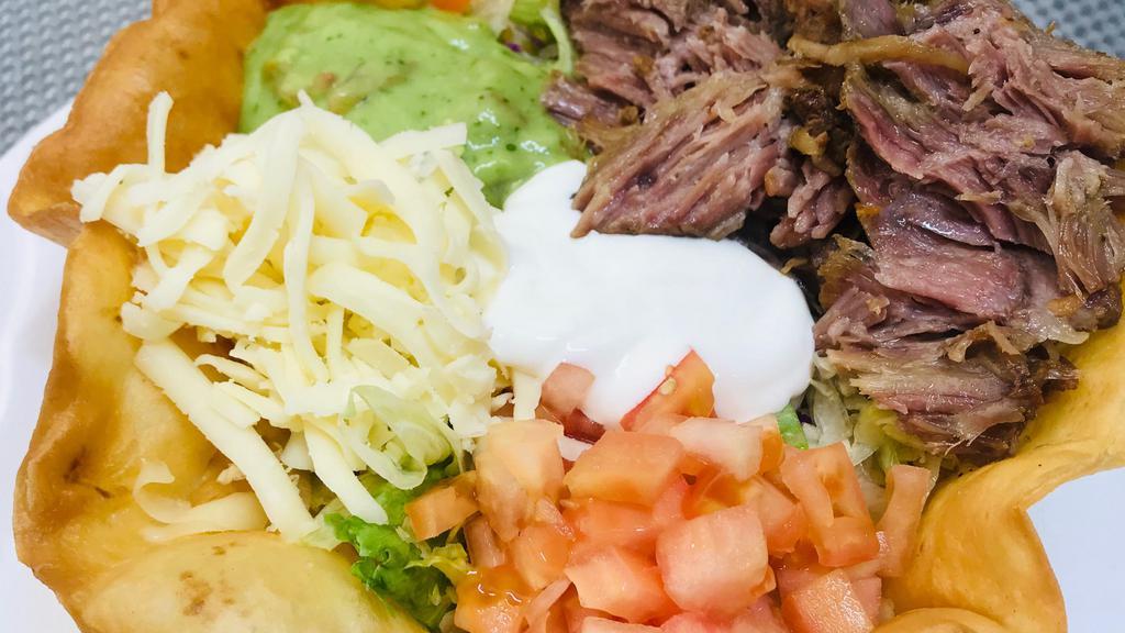 Taco Salad · Your choice of meat with beans, Monterey cheese,  lettuce, tomato, sour cream and guacamole over a fried and crunchy flour tortilla shell.