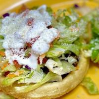 Sope Clásico · A corn base with beans, and your choice of meat, topped with lettuce, tomato, cheese and sou...