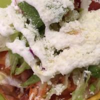 Tostada Clásica · Crunchy corn tortilla with beans, your choice of meat, lettuce, tomato, cheese, and sour cre...