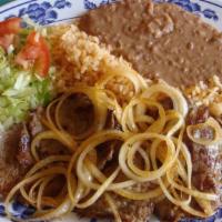 Carne Asada · Delicious, grilled steak with grilled onions on top. Served with rice, beans, salad and tort...