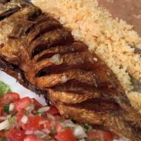 Fried Fish (pescado frito) · Exquisite red snapper deep-fried to perfection. Served, with rice, beans, fresh pico de gall...