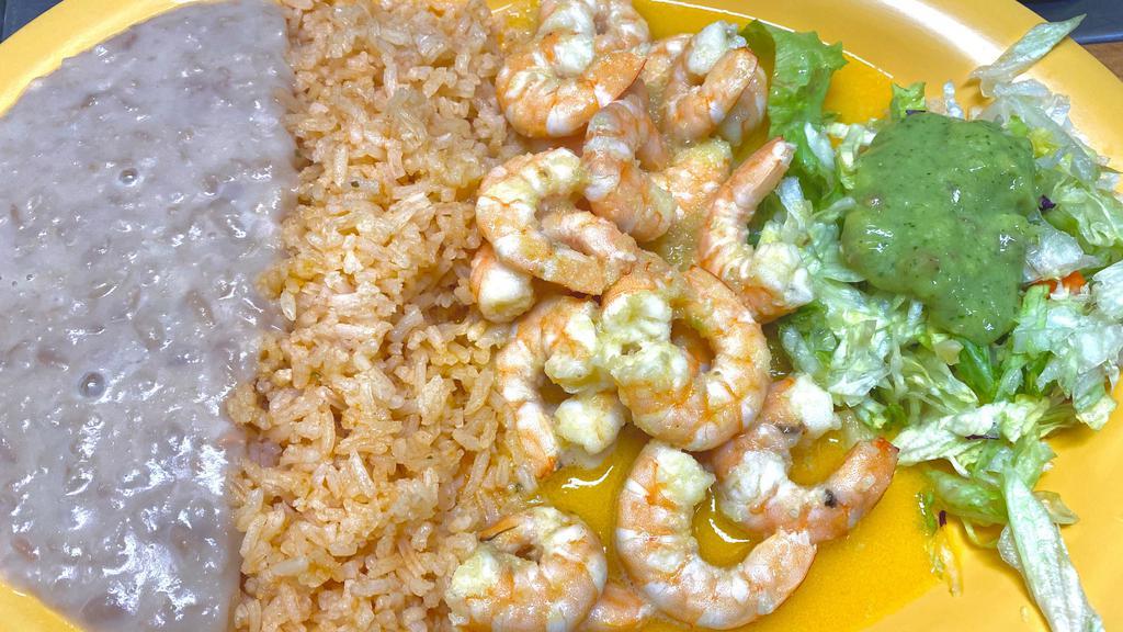 Camarones al Mojo de Ajo · Succulent grilled shrimp in our special garlic sauce. Served with our delicious rice, beans, a small salad and warm tortillas.