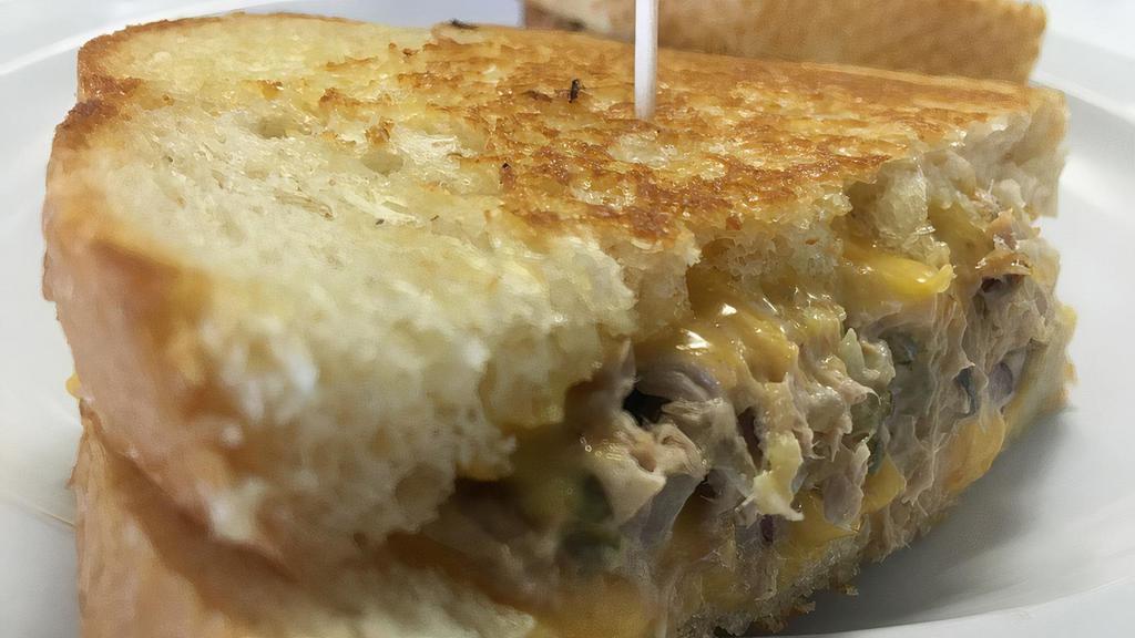 Tuna Melt · Our own tuna salad grilled with melted with cheddar cheese.