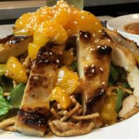 Chinese Chicken Salad · Chopped romaine and cilantro topped with peanuts, man Darin oranges, crispy noodles, and plu...
