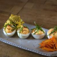 Curried Deviled Eggs · Gluten free. Vegetarian. Served with house made pickles.