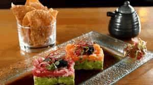 Tomodashi Tartare · Maguro tuna and salmon tartare, avocado, black tobiko, citrus, ponzu, and spicy oil, served ...