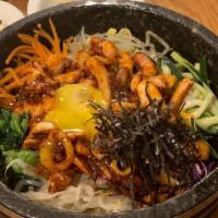 57. BIBIMBAP · Steamed rice topped with beef, vegetables and fried egg saved with spicy sauce.