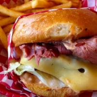 Pastrami Hot Sandwich · Thinly sliced pastrami and swiss cheese topped with poppy seeds served with potato wedges.